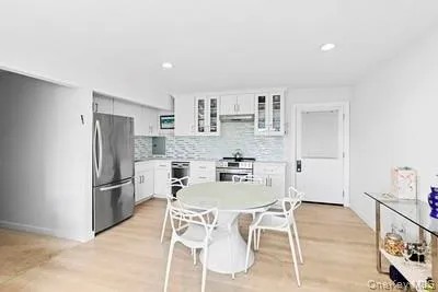 a kitchen with stainless steel appliances kitchen island granite countertop a refrigerator and a stove top oven