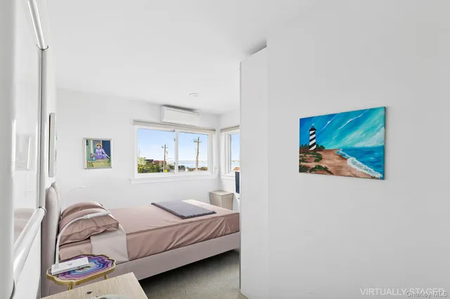 a bedroom with a bed and a painting on the wall