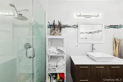 a bathroom with a sink vanity and a mirror