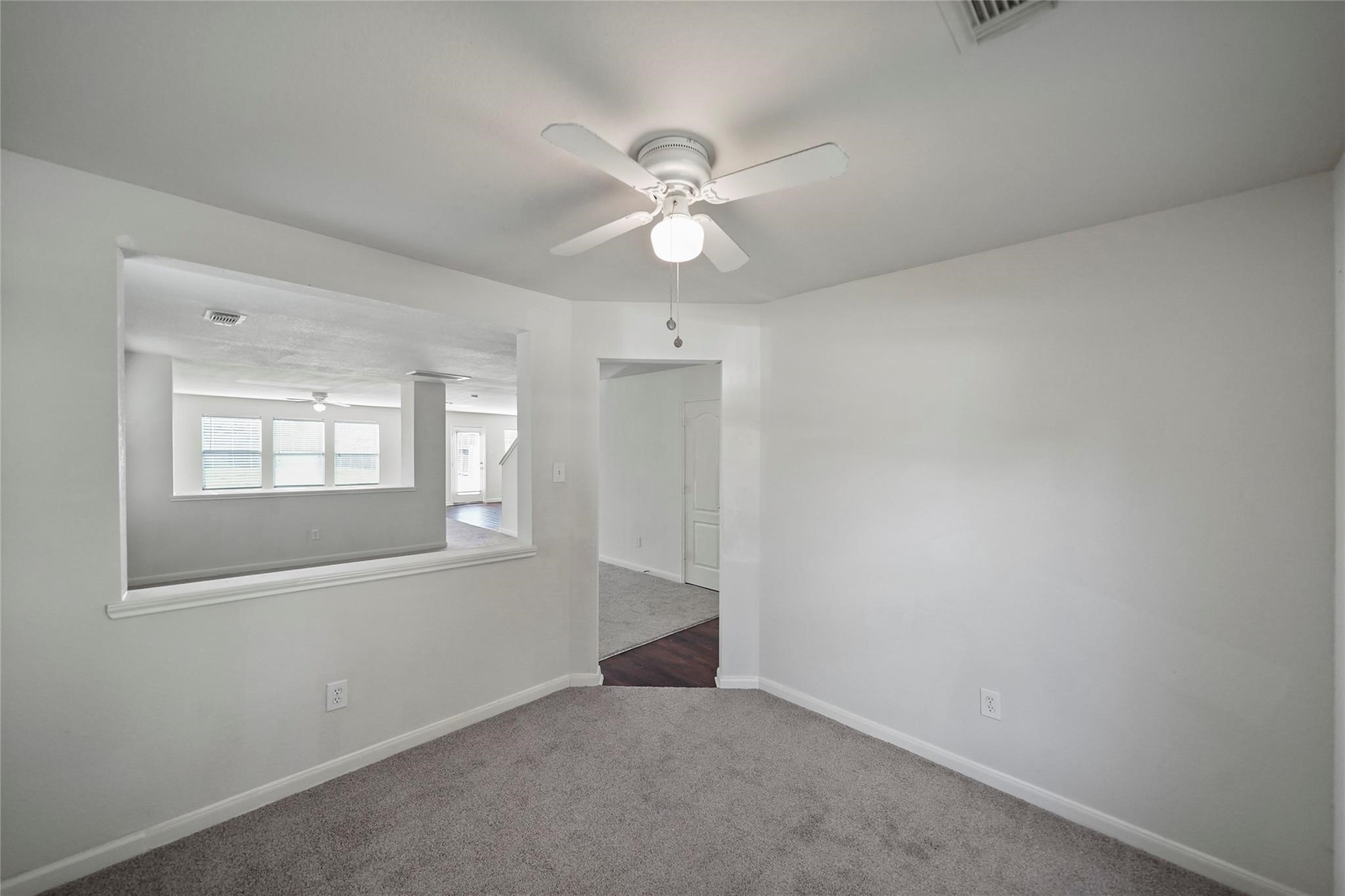3610 Avalon Castle Drive Spring, TX 77386 - Photo 18 of 23 an empty room with chandelier fan and windows