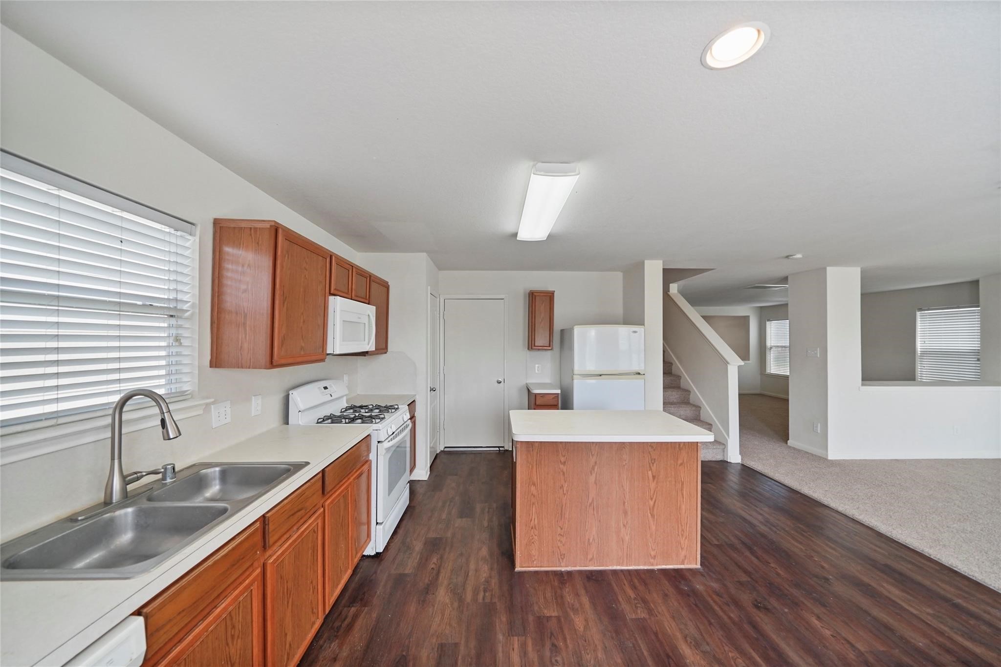 3610 Avalon Castle Drive Spring, TX 77386 - Photo 7 of 23 a large kitchen with a wooden floor and a sink