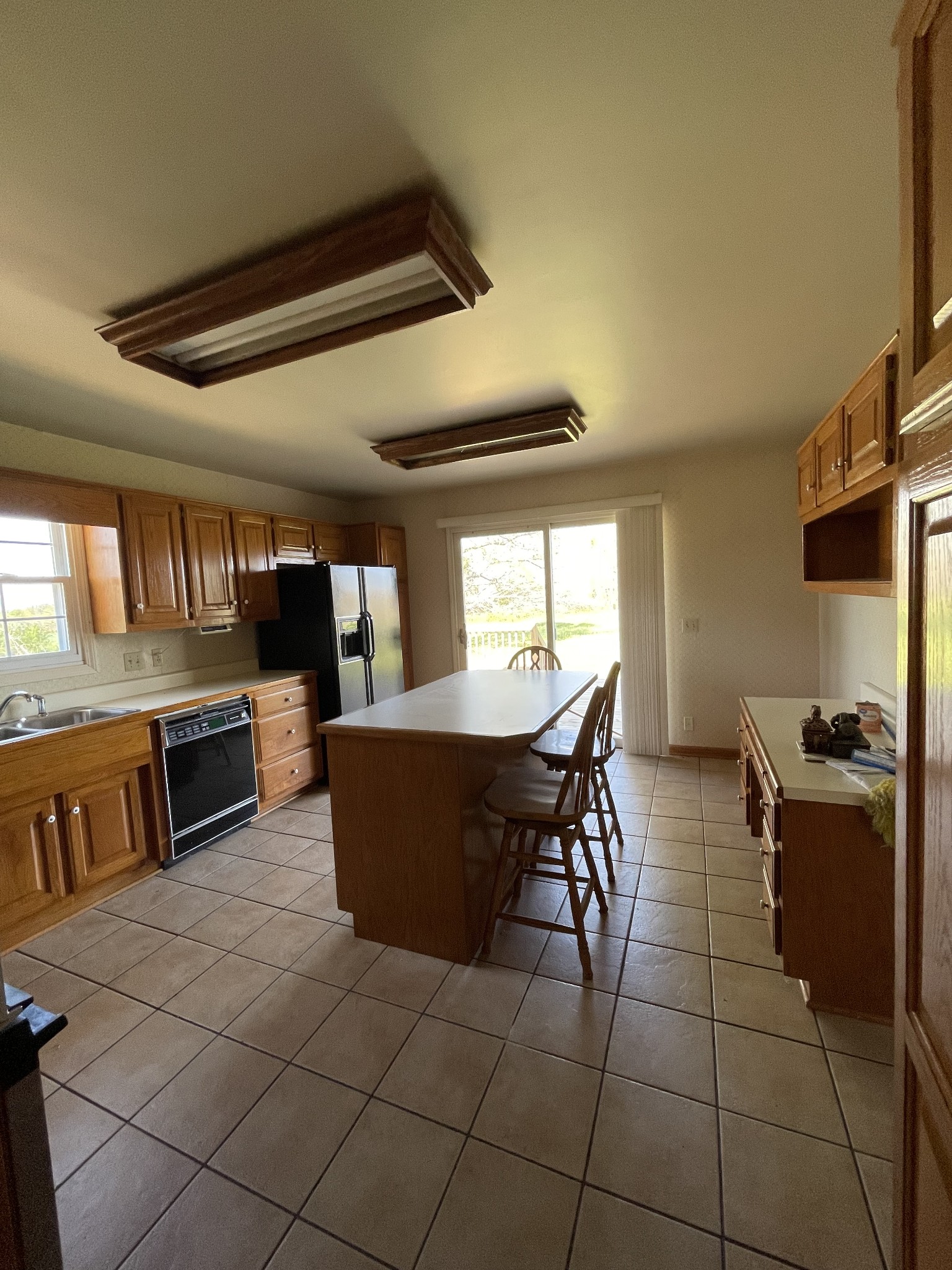912 Long Creek Road Lafayette, TN 37083 - Photo 6 of 21 a kitchen with stainless steel appliances granite countertop a stove a sink dishwasher a dining table and chairs with wooden floor