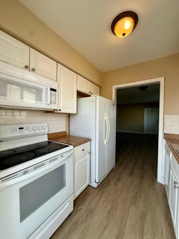 a kitchen with a stove and a refrigerator