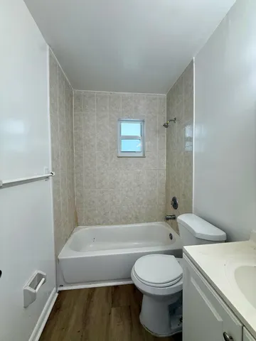 a bathroom with a toilet and a bathtub
