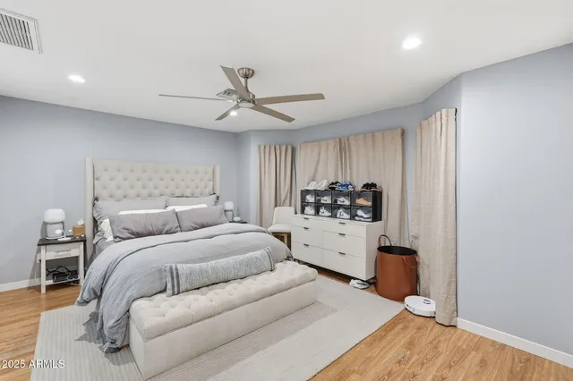 a room with a bed and a dresser