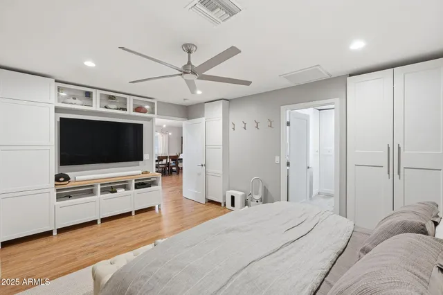 a bedroom with furniture and a flat screen tv
