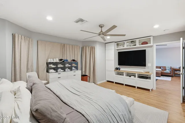 a bedroom with a bed and a flat screen tv
