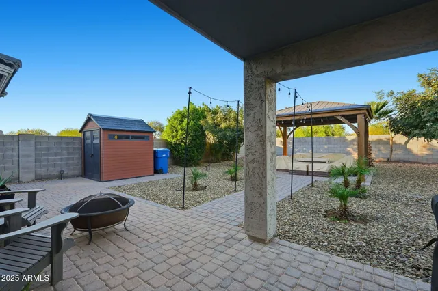 a backyard of a house with yard and outdoor seating