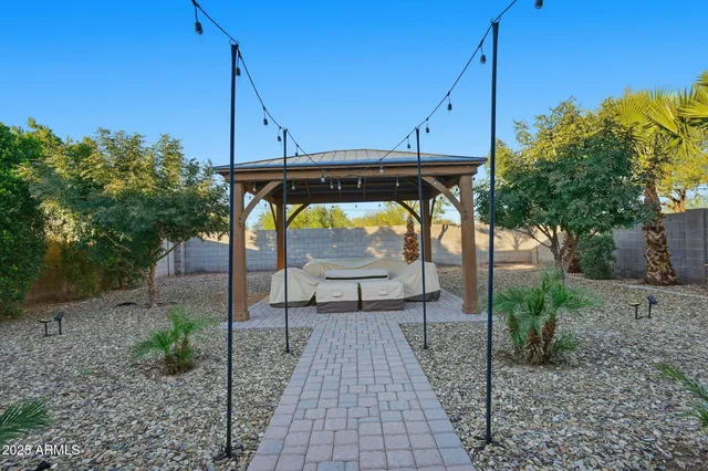 a view of a chairs and table in the backyard