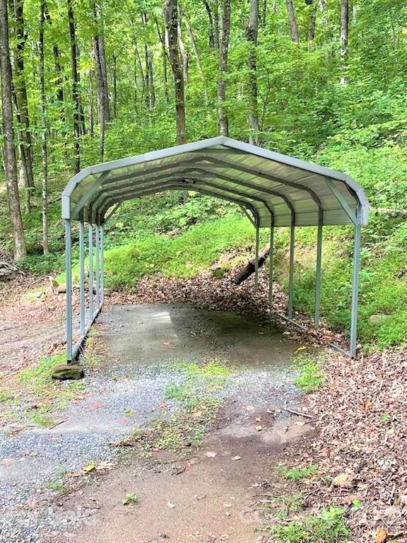 1730 Judes Gap Road, Unit 29 Mill Spring, NC 28756 - Photo 16 of 33 a backyard of a house with large trees and plants