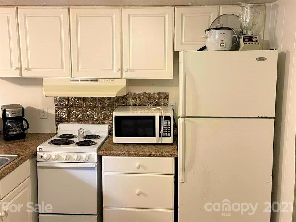 1730 Judes Gap Road, Unit 29 Mill Spring, NC 28756 - Photo 4 of 33 a kitchen with a stove and a refrigerator