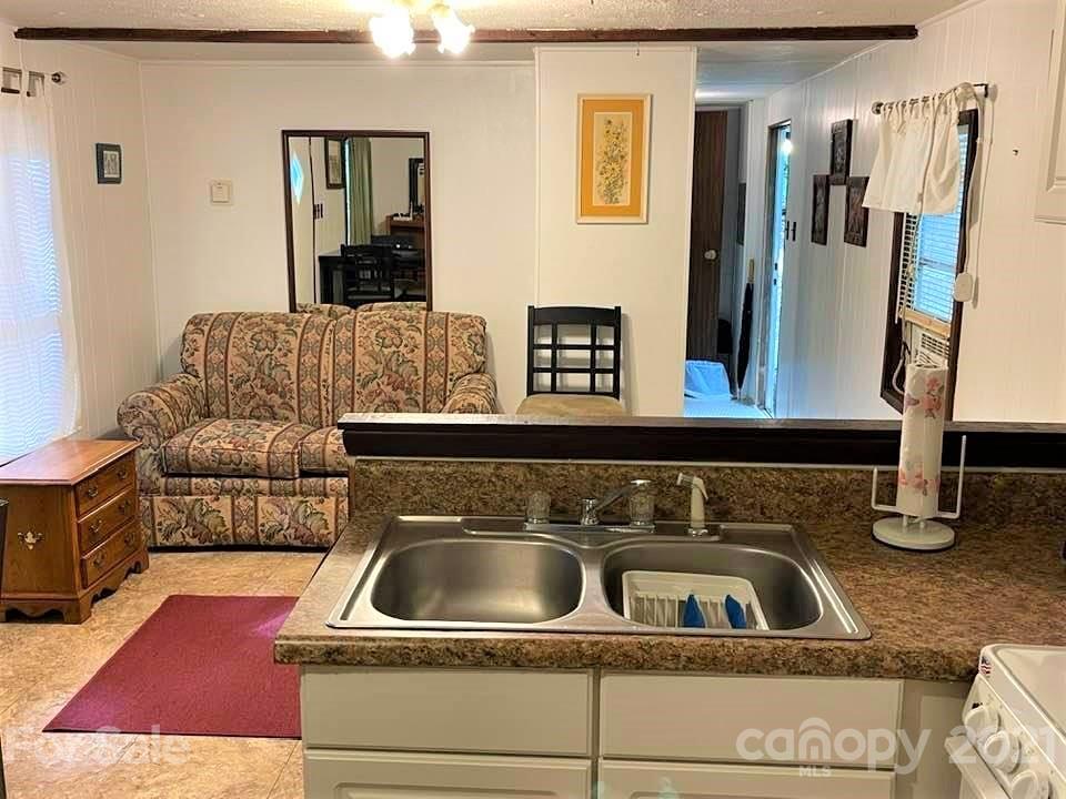 1730 Judes Gap Road, Unit 29 Mill Spring, NC 28756 - Photo 7 of 33 a kitchen with a sink and a refrigerator