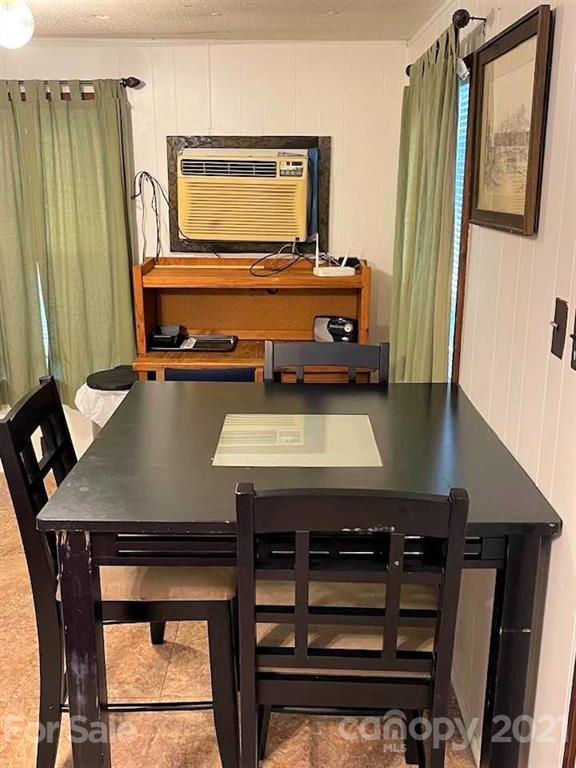 1730 Judes Gap Road, Unit 29 Mill Spring, NC 28756 - Photo 8 of 33 a living room with a table chairs and windows