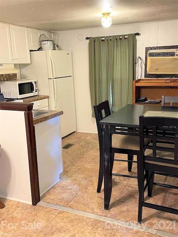 1730 Judes Gap Road, Unit 29 Mill Spring, NC 28756 - Photo 10 of 33 a kitchen with stainless steel appliances granite countertop a stove a refrigerator and a microwave