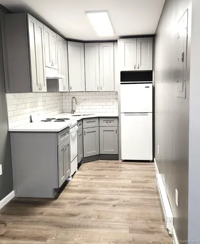 a kitchen with a sink a refrigerator and window