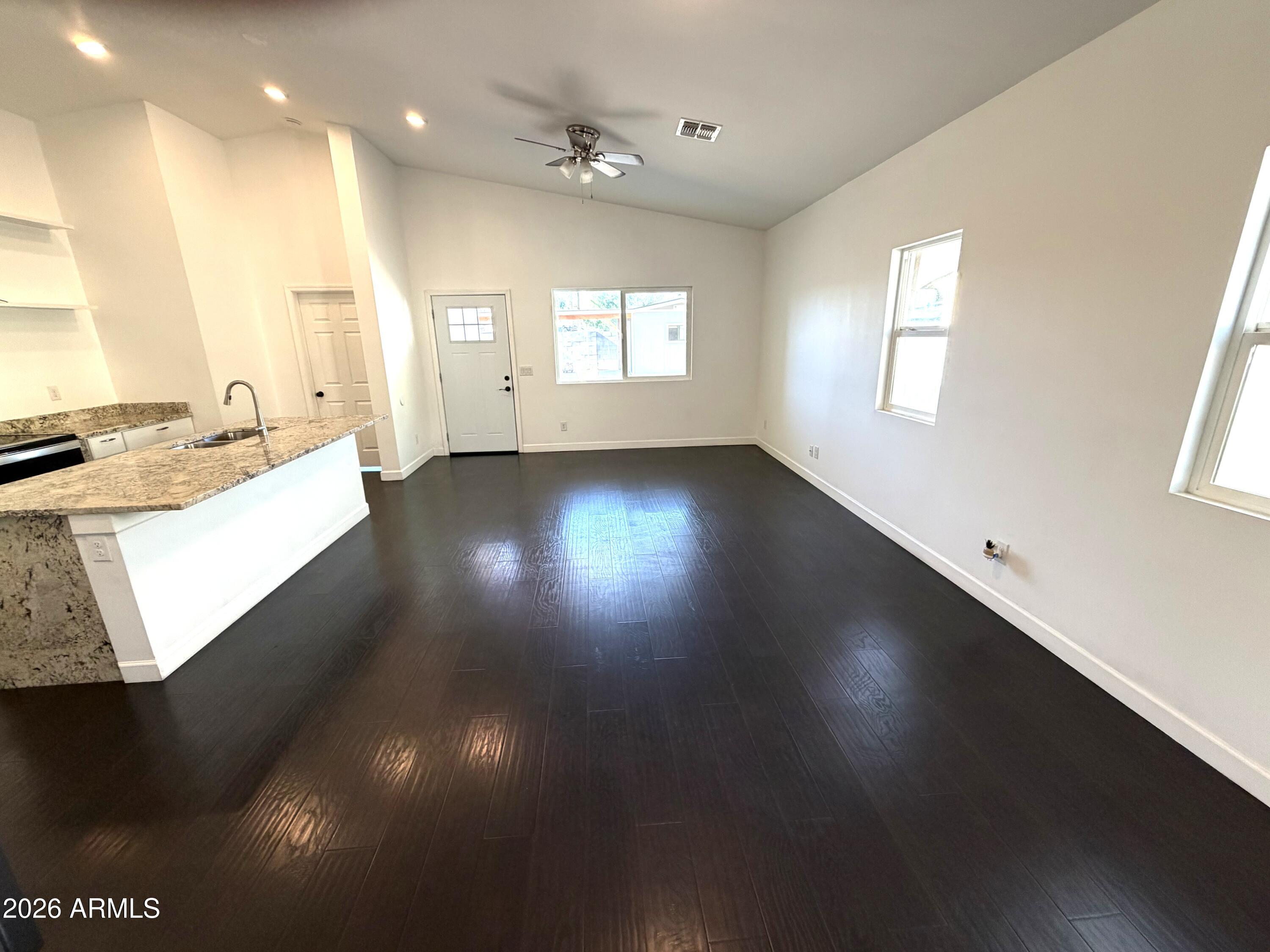 1924 West Lawrence Road Phoenix, AZ 85021 - Photo 15 of 17 a view of an empty room with wooden floor and a window
