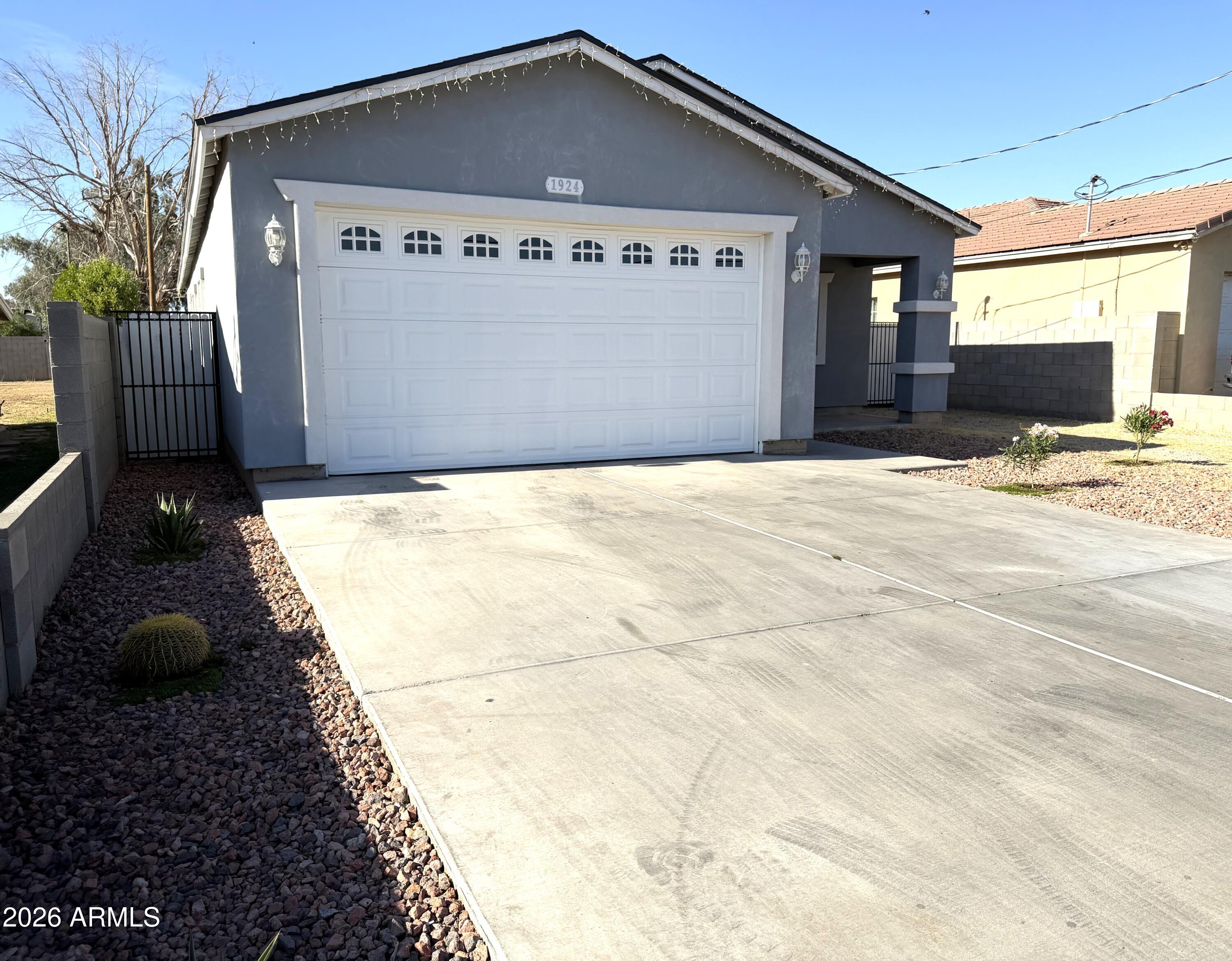 1924 West Lawrence Road Phoenix, AZ 85021 - Photo 3 of 17 a front view of a house with garage