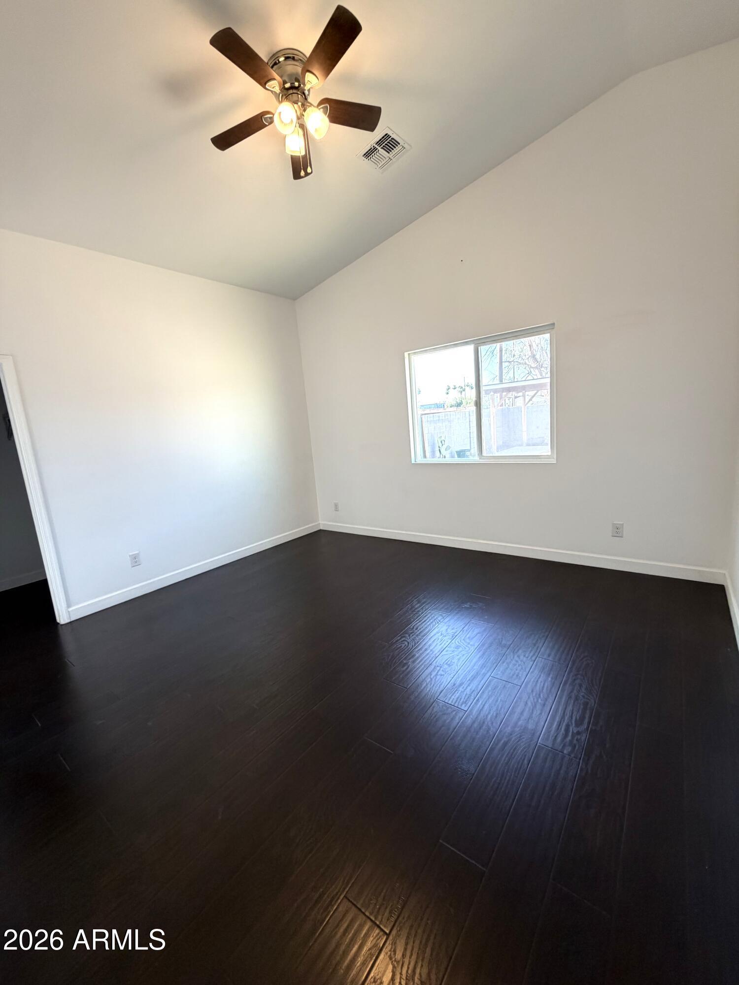 1924 West Lawrence Road Phoenix, AZ 85021 - Photo 10 of 17 en empty room with wooden floor and windows
