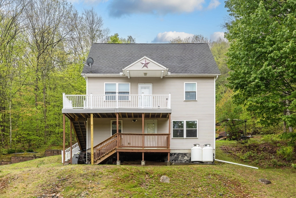 a front view of a house with a yard balcony