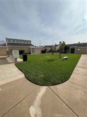 an aerial view of a house with a yard and sitting area
