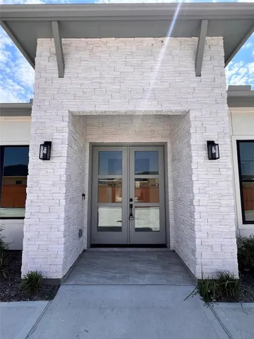 a view of front door of house with stairs