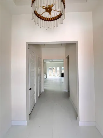 a view of a hallway with wooden shelves