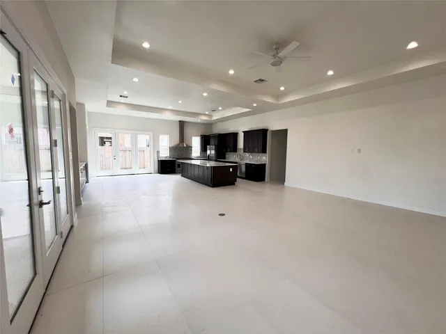 a large kitchen with lots of counter space and stainless steel appliances
