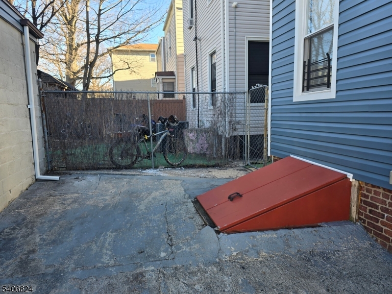 53 Aldine Street Newark, NJ 07112 - Photo 13 of 14 a backyard of a house with table and chairs