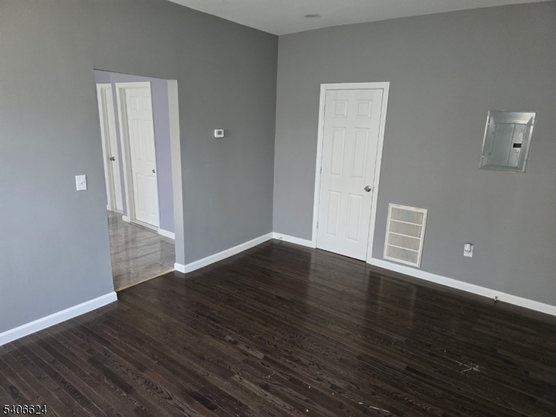 53 Aldine Street Newark, NJ 07112 - Photo 4 of 14 a view of an empty room with wooden floor and closet
