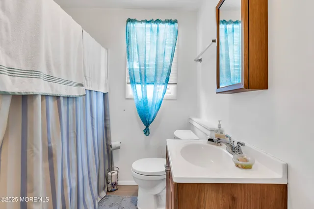 a dining hall with stainless steel appliances granite countertop a sink dishwasher a dining table and chairs with wooden floor