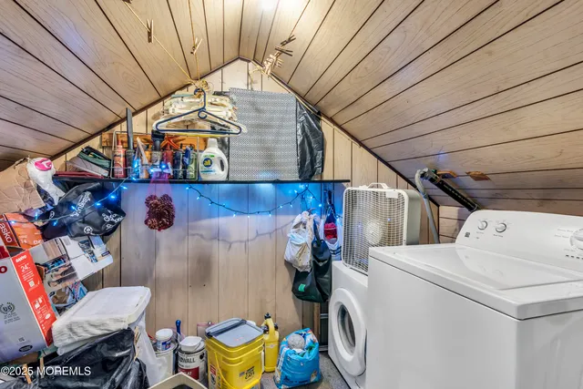 a kitchen with stainless steel appliances granite countertop white cabinets a sink a stove a refrigerator and island with wooden floors