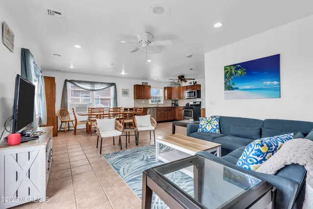 a living room with a bed furniture and next to a window