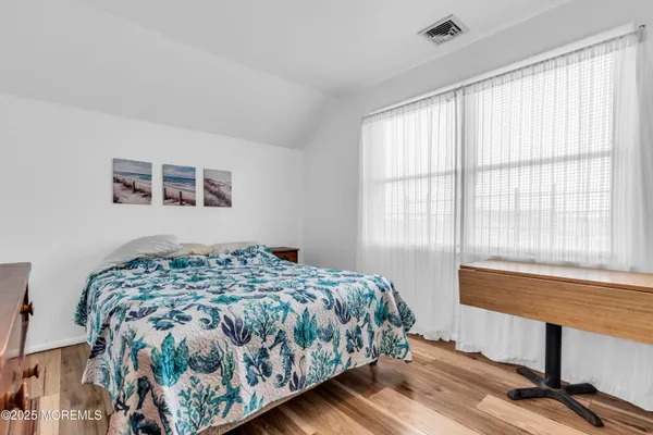 a bedroom with a bed and a chair
