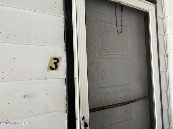 a dining room with furniture and a window