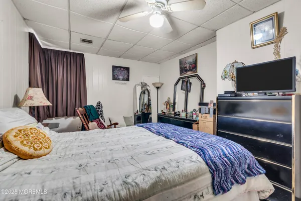 a bedroom with bed and flat screen tv