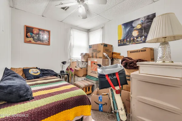 a living room with furniture a flat screen tv and a dining table