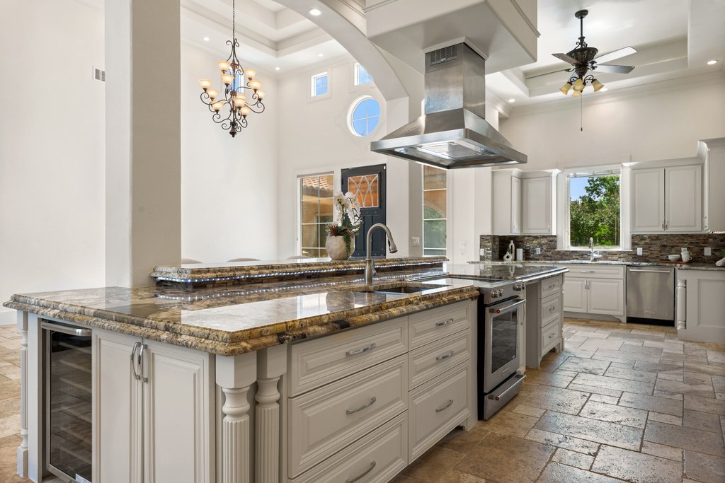 102 Long Point Cove Georgetown, TX 78628 - Photo 11 of 36 a kitchen with a sink counter top space appliances and a chandelier