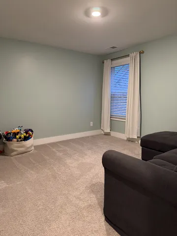 a living room with furniture and a cabinet