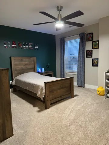 a bedroom with a bed and a flat tv screen