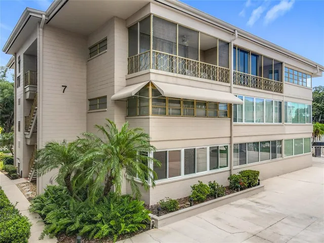 a front view of a building with a garden