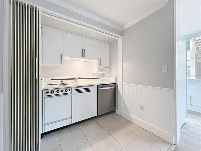 a kitchen with a stove top oven and sink