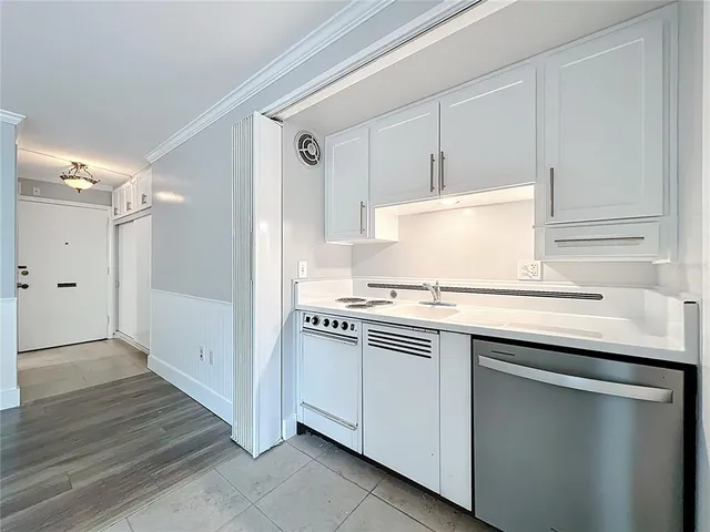 a kitchen with cabinets appliances and a counter space