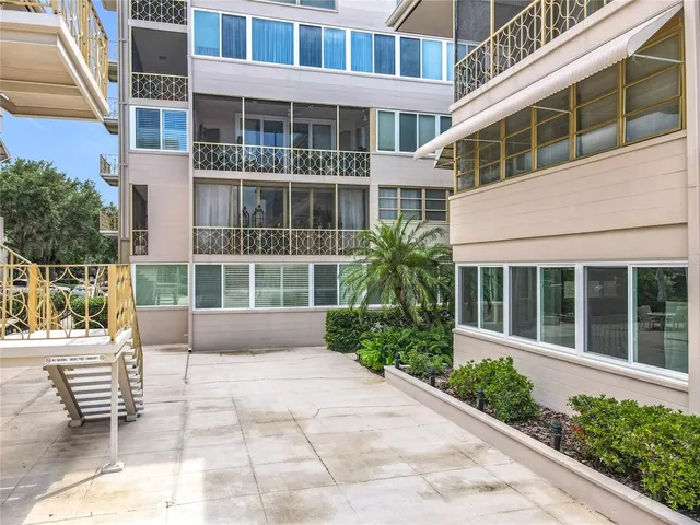 a front view of a building with a garden