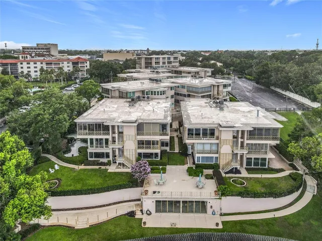 a aerial view of multiple houses with a yard