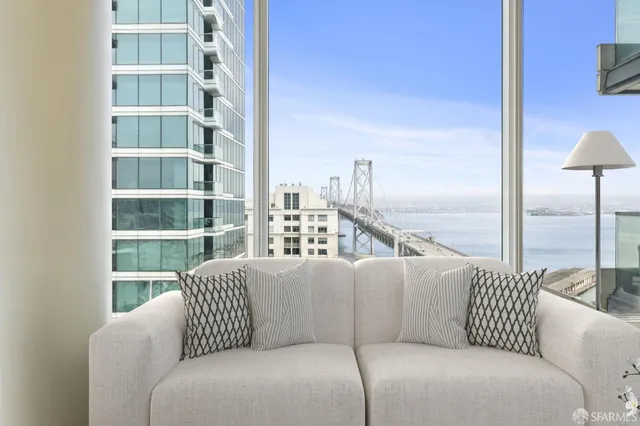 a balcony with furniture and a book shelf