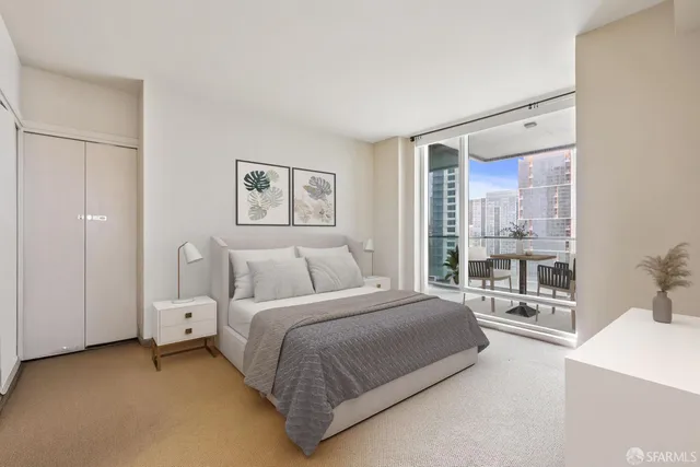 a bedroom with a large bed and a large window