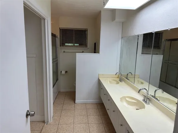 a bathroom with a double vanity sink and mirror