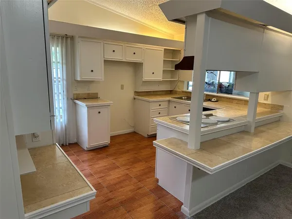 a kitchen with white cabinets and white appliances