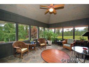 1380 Pkwy N Road Mill Spring, NC 28756 - Photo 16 of 24 a living room with patio furniture and a floor to ceiling window