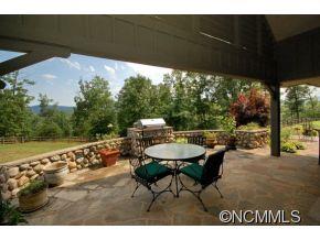 1380 Pkwy N Road Mill Spring, NC 28756 - Photo 22 of 24 a view of a patio with a table chairs and a swimming pool